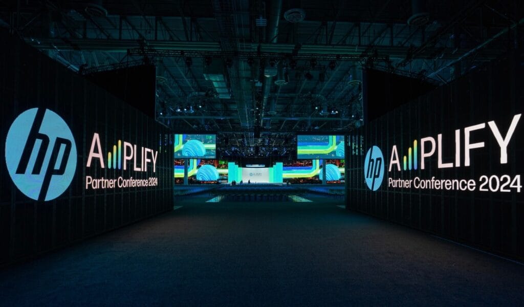 HP Amplify Partner Conference 2024 entrance with large illuminated signage and vibrant screens