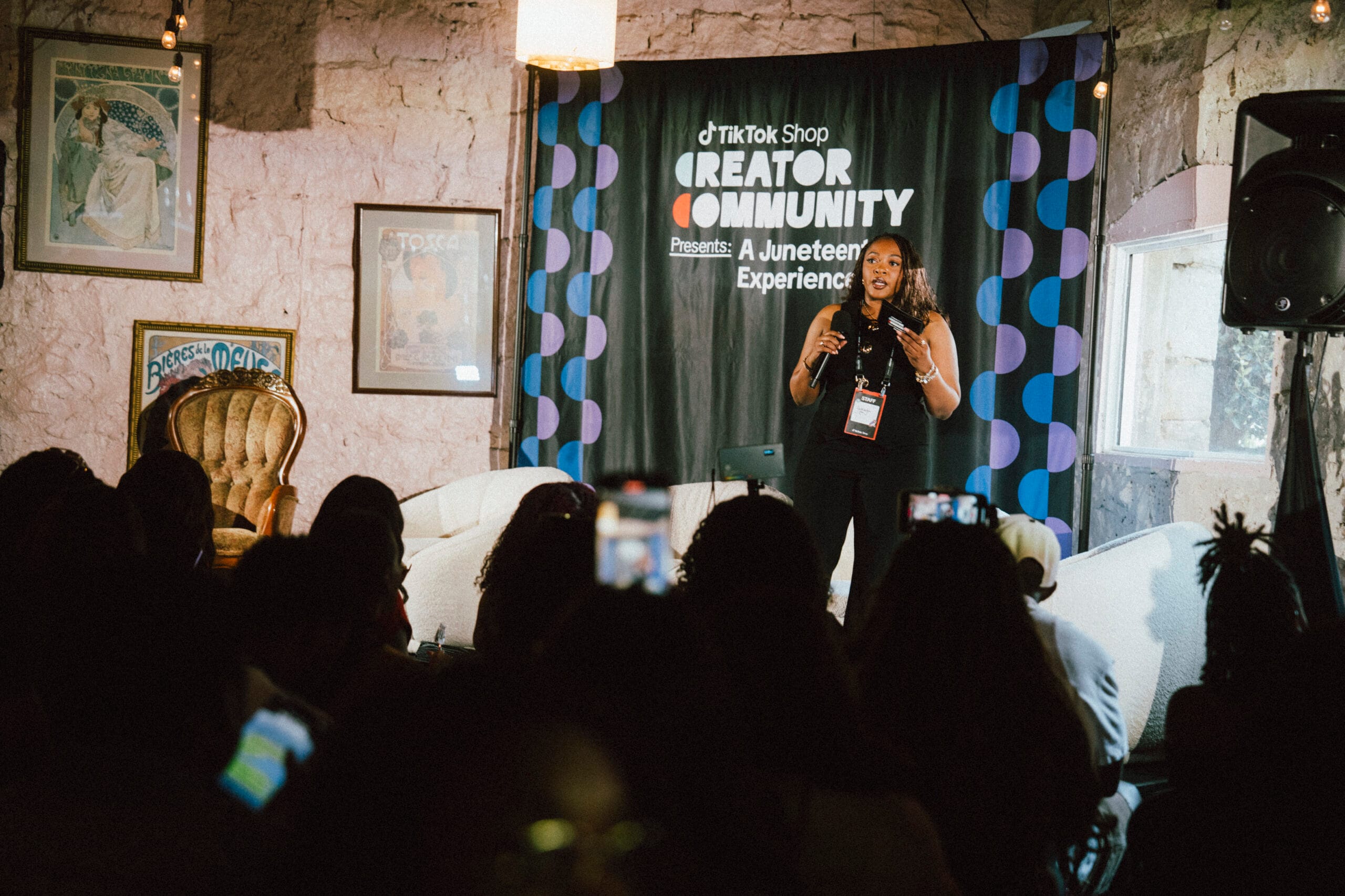 A solo female black influencer is speaking on stage at TikTok Shops Juneteenth event in Atlanta, 2025.
