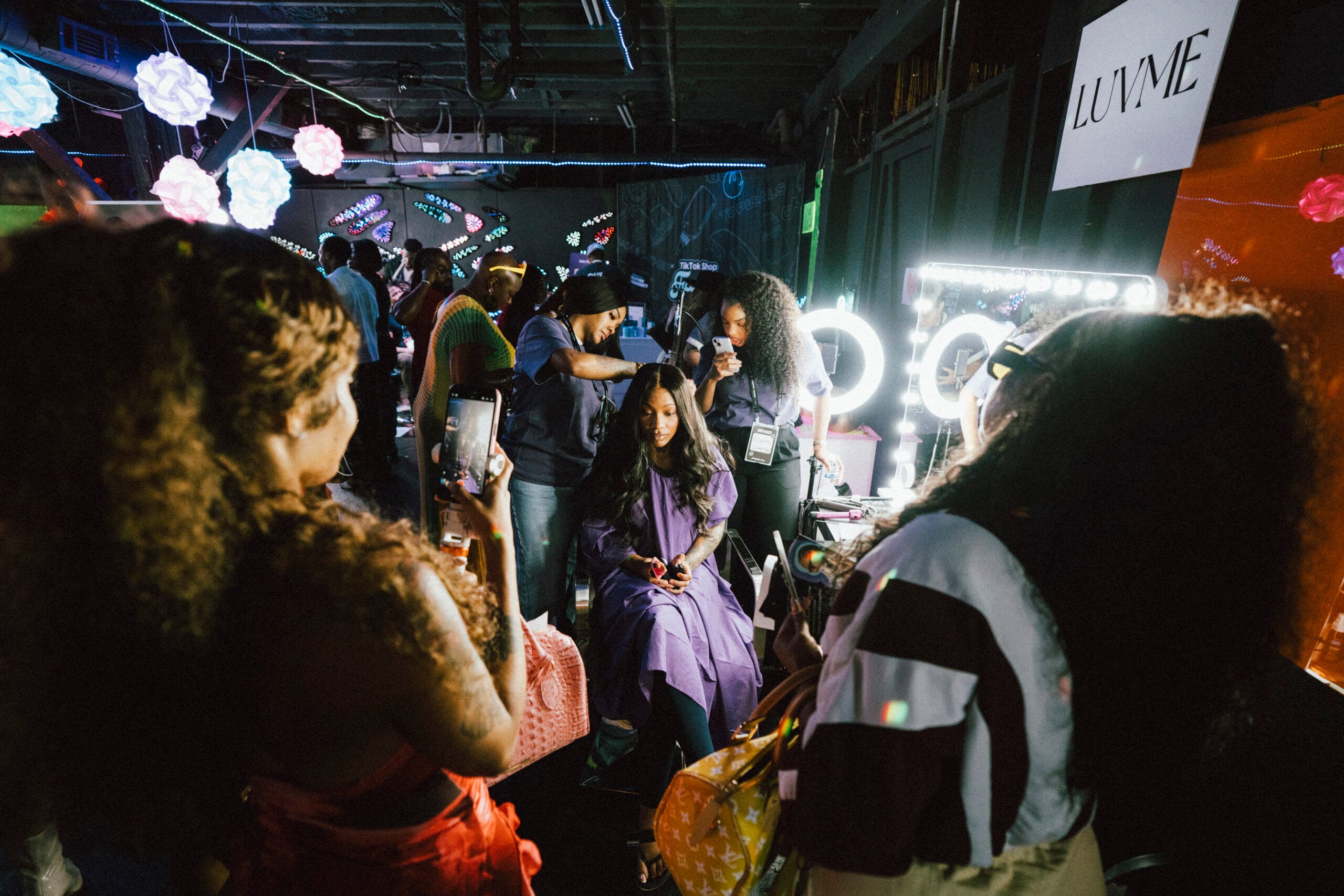 Black woman getting her hair styled at the Luvme Beauty booth during the TikTok Shop Juneteenth Experience in Atlanta.